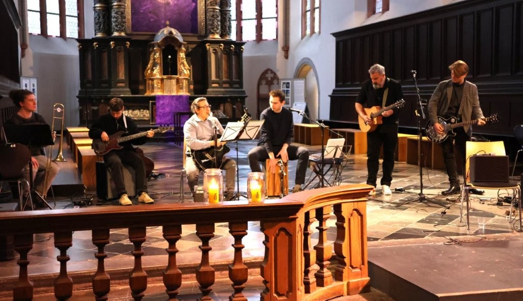 Im Altarraum der Citykirche spielt eine Band mit unterschiedlichen Instrumenten.